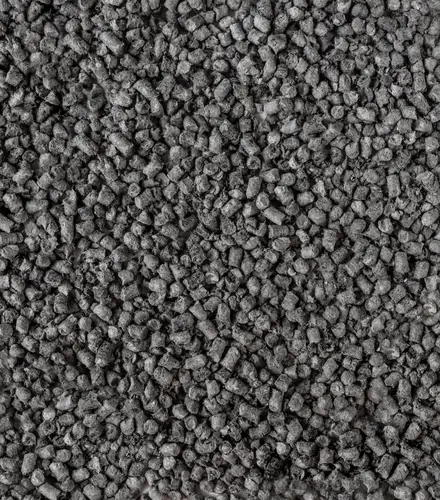 A layer of dark grey HLB-FIBER pellets filling the frame, seen from above