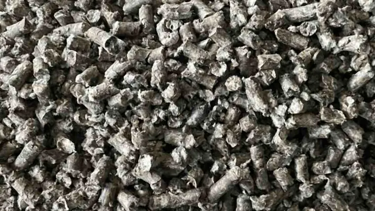 A deep layer of grey HLB-FIBER pellets seen from above