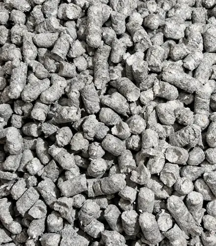 Close-up of grey HLB-FIBER pellets, short cylinders with rough, fibrous ends